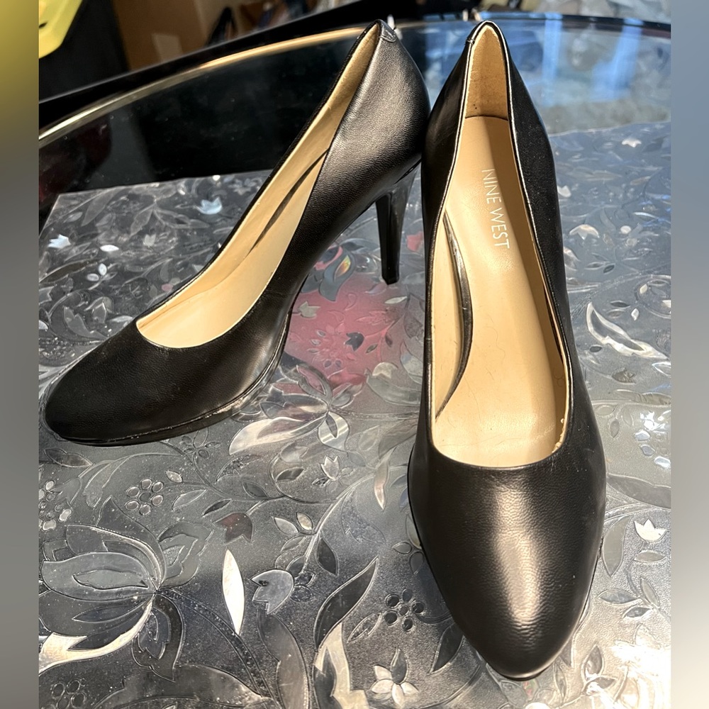 Used Nine West black leather high heels.  Size 8.5. Worn once.  Great condition.